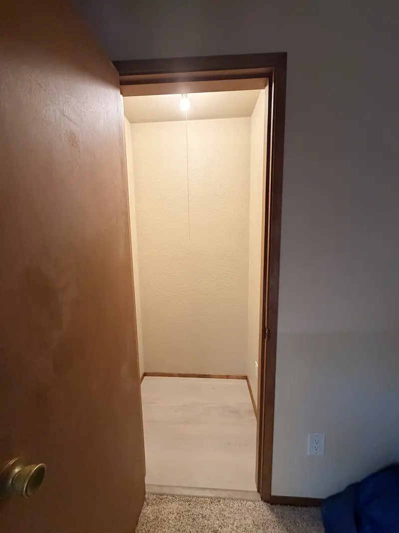 Closet doorway showing new light plank flooring
