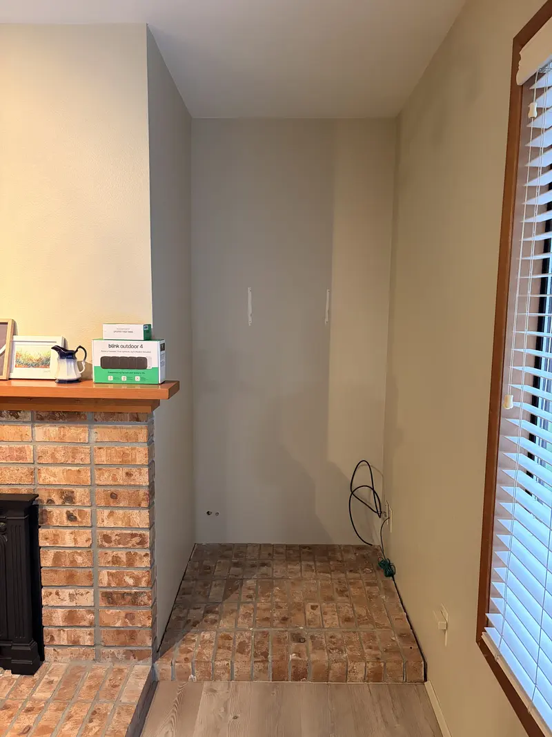 Alcove beside a brick fireplace before repair