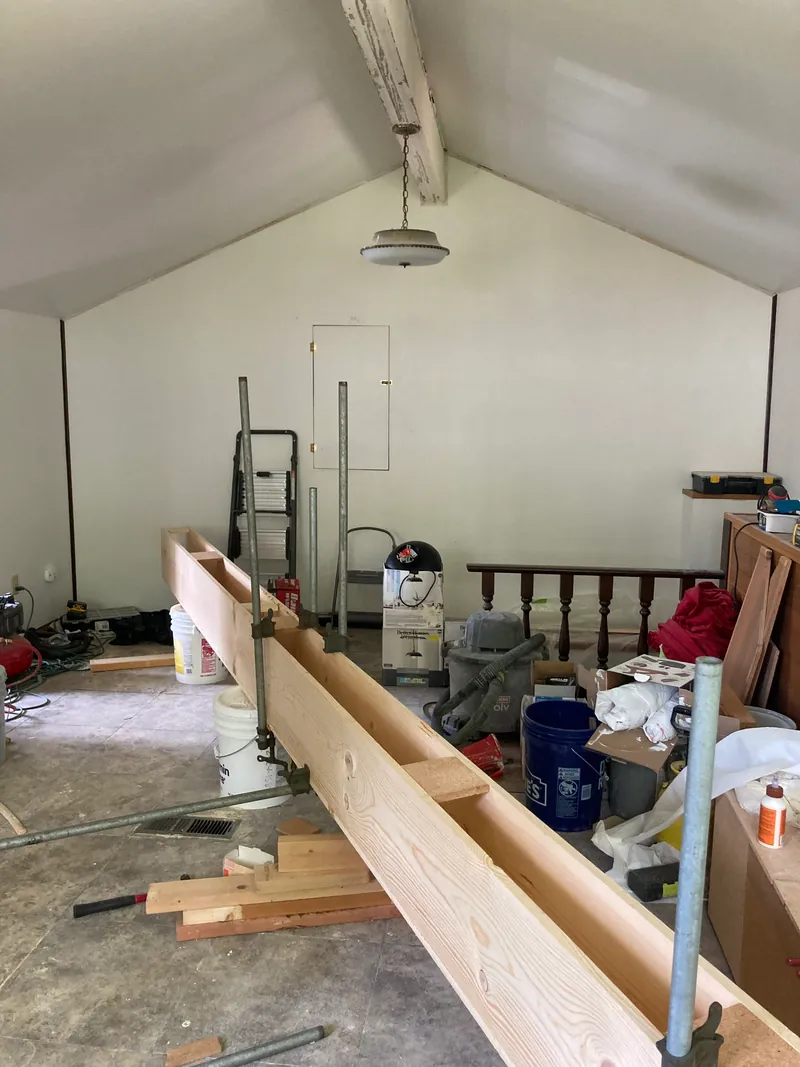 Box beam assembled on the loft floor among tools and lumber