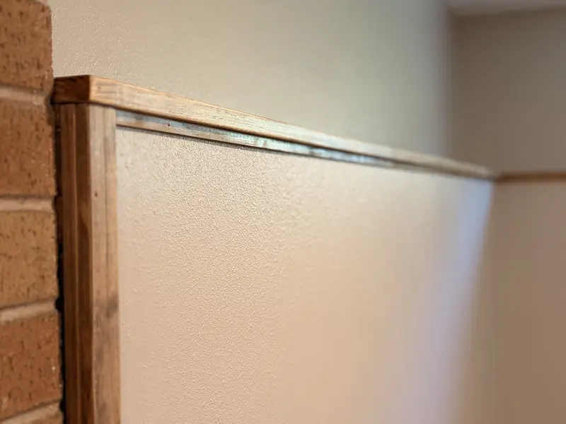 Stained wood cap trim along the top of a half wall